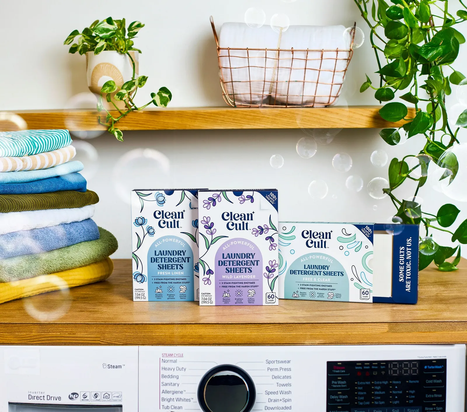 Three boxes of Cleancult laundry sheets on a laundry room counter.