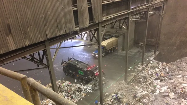 View of a truck tipping waste on the floor of an industrial incineration facility