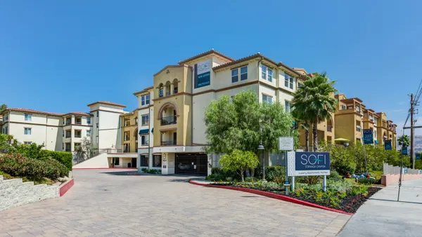 Brown four-story apartment community