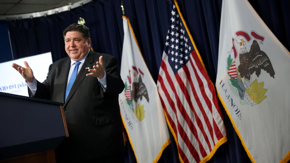 Illinois Governor J.B. Pritzker speaks at podium