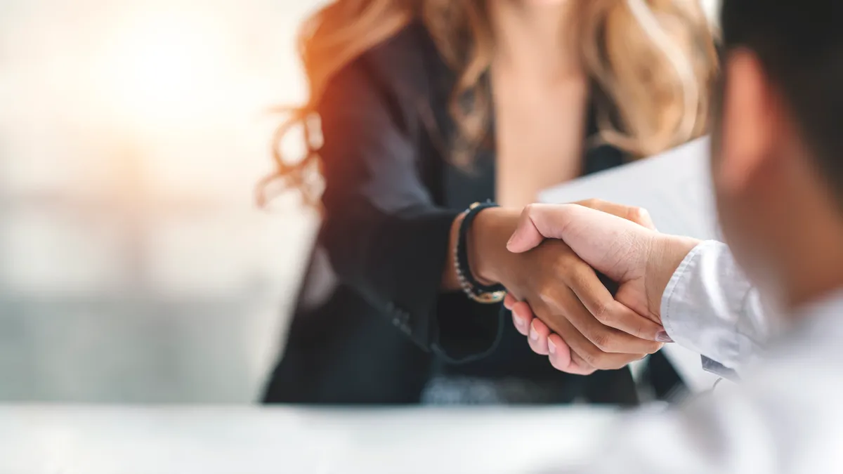 Two business people shaking hands