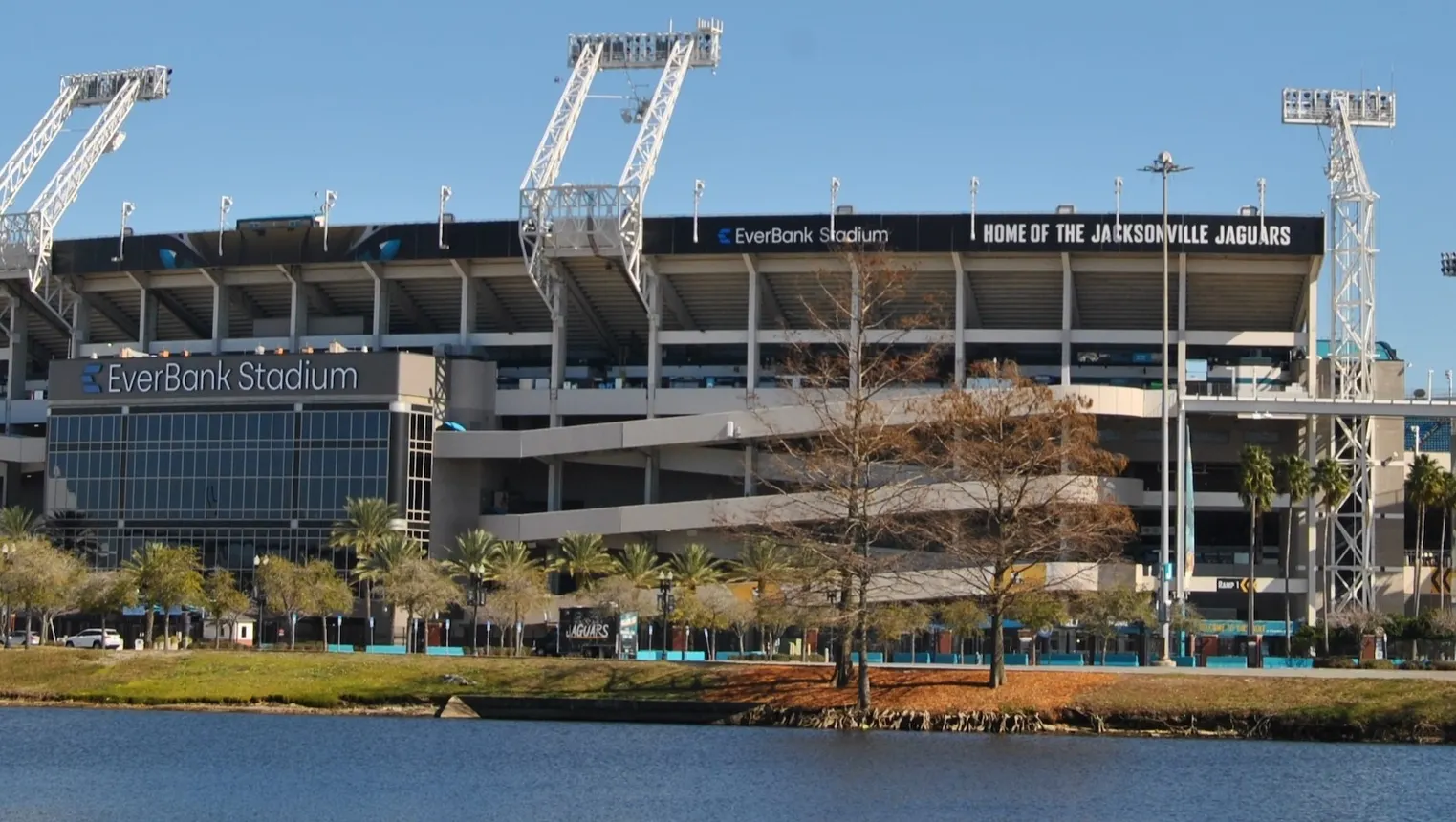 A shot of a stadium from across a body of water. The words &quot;EverBank Stadium&quot; can be seen on the front of the structure.
