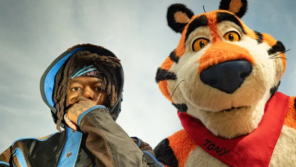 Rap artist JID with Frosted Flakes brand mascot Tony the Tiger.
