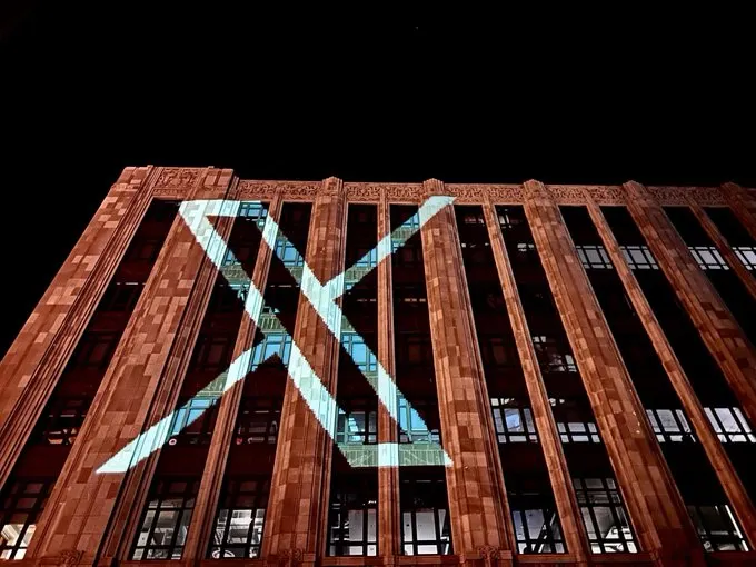 A projection of the new Twitter logo, X, on the company's headquarters