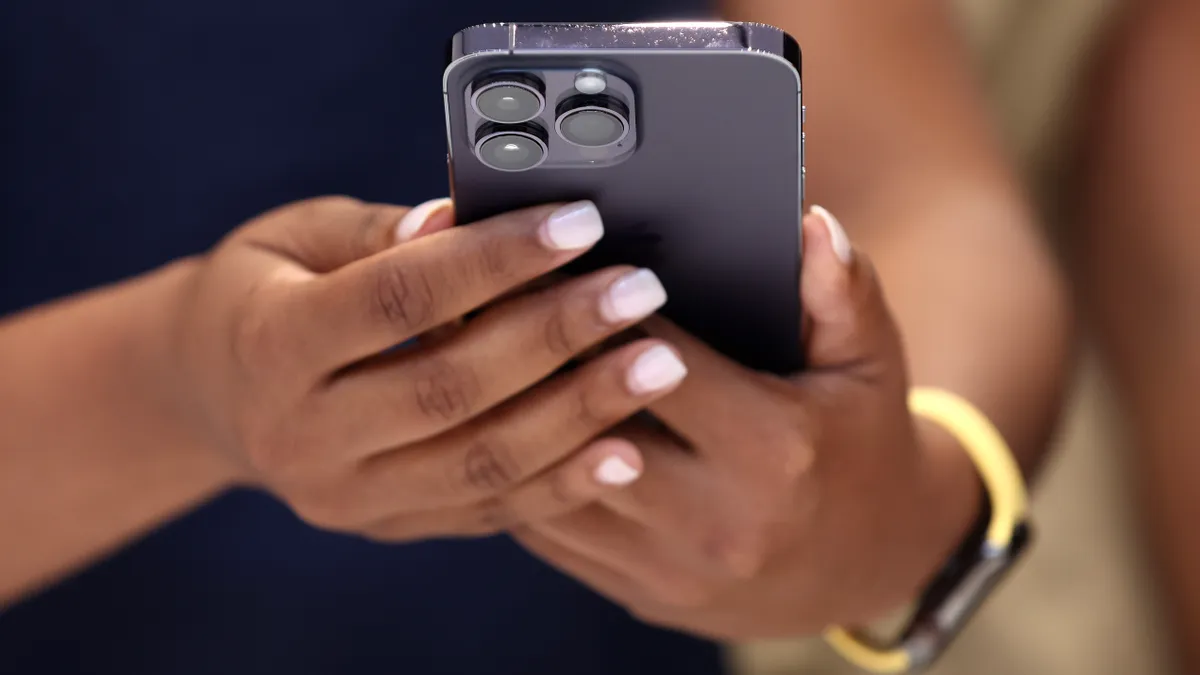 An attendee holds a new Apple iPhone 14 Pro during an Apple special event on September 07, 2022 in Cupertino, California.