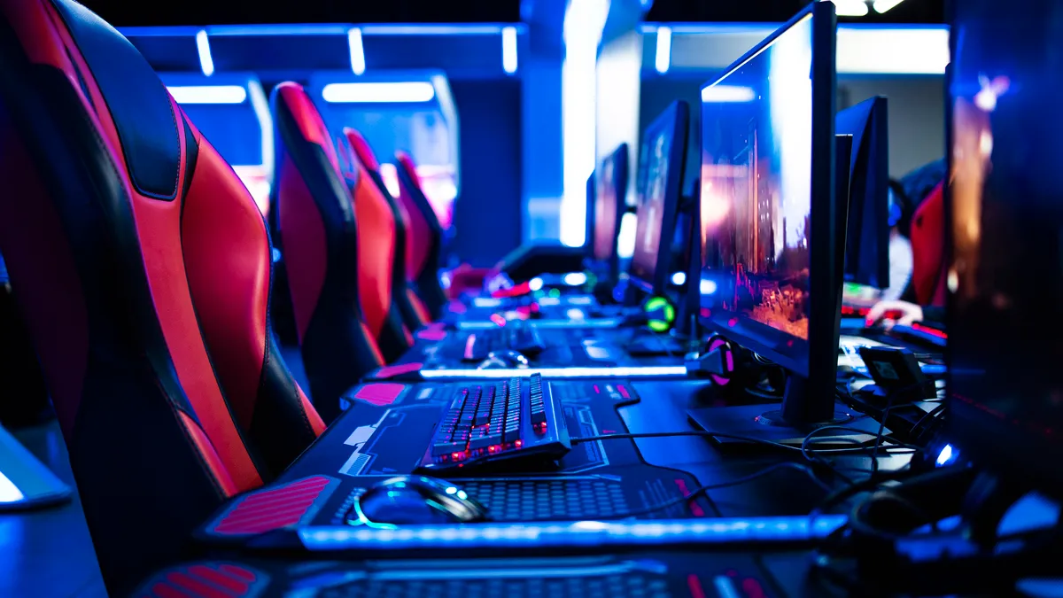 Gaming chairs lined up with computers.