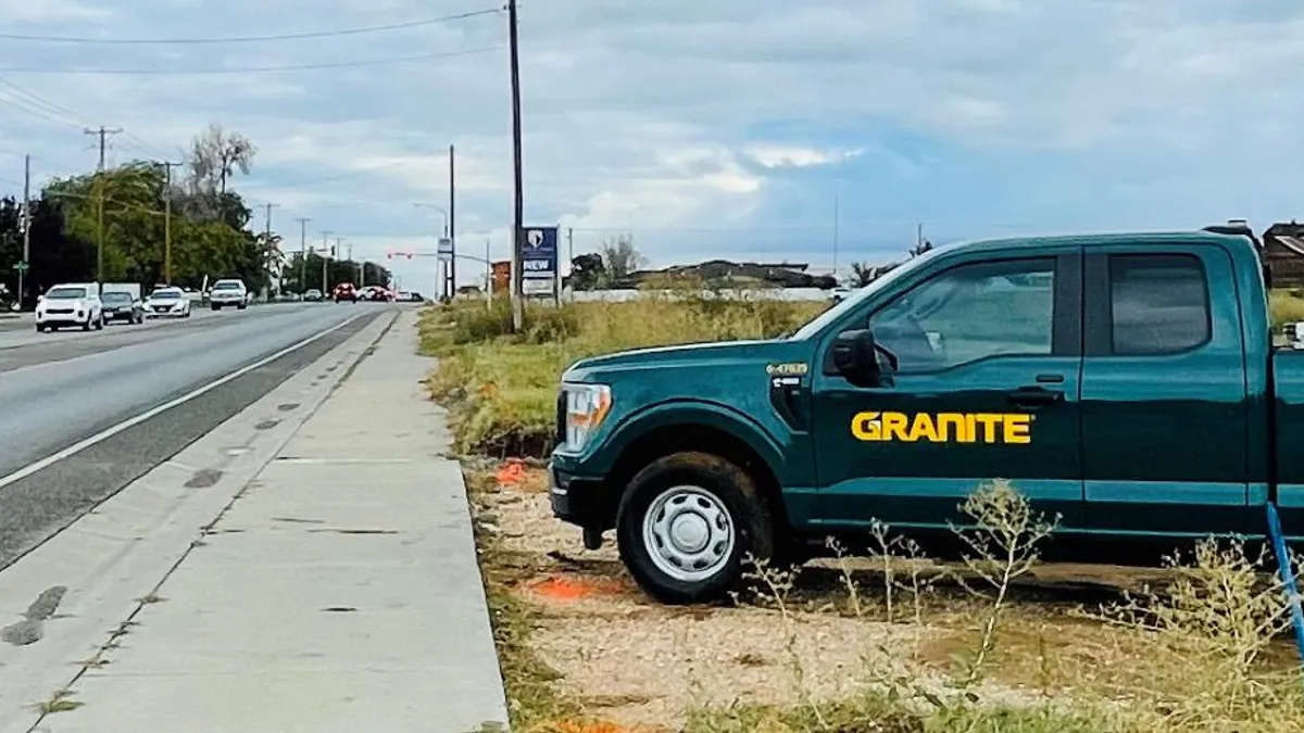 A Granite Construction pickup truck is parked alongside a highway in Utah.