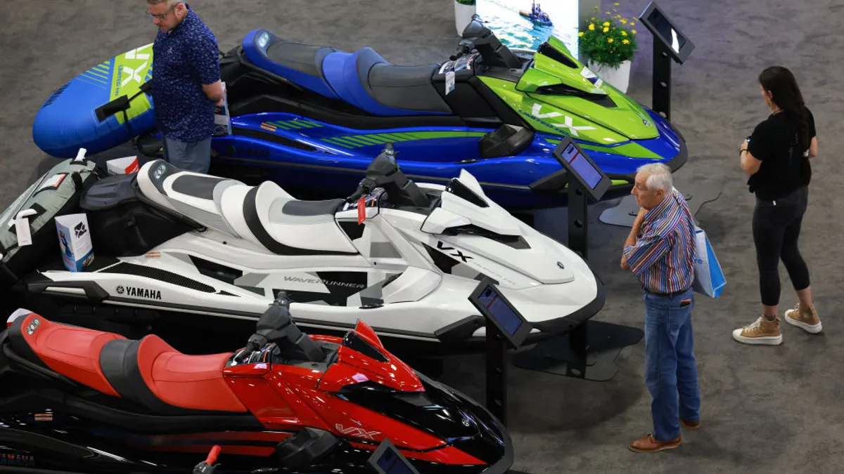 People look at Yamaha watercraft on display at a Miami Beach, Florida, boat show.