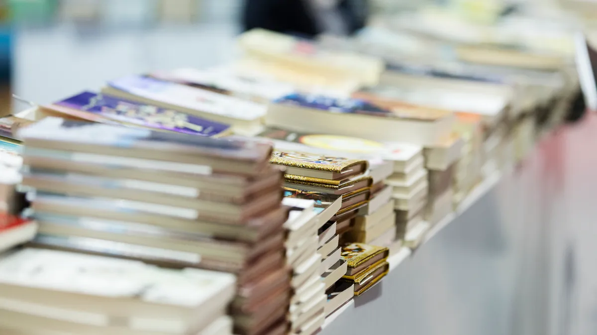 Books stacked at a fair