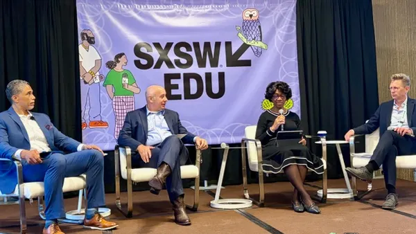 Four people are sitting in chairs on a stage. There is a banner behind them that reads "SXSW EDU"
