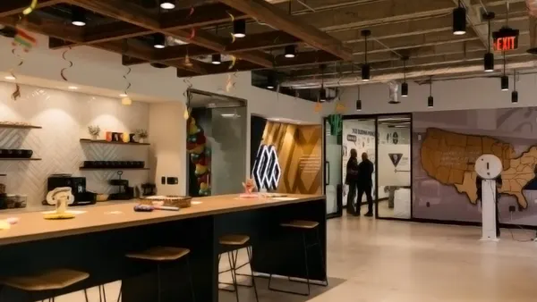 An interior of a modern space with wood furniture, glass and a sleek parts.