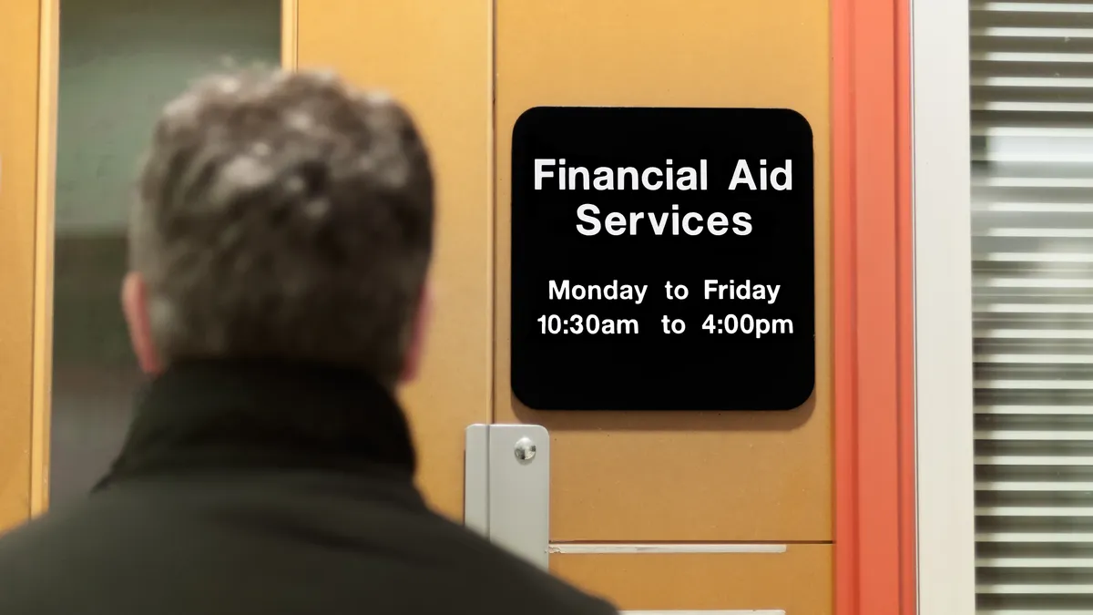 A college student waits to enter a college financial aid office.