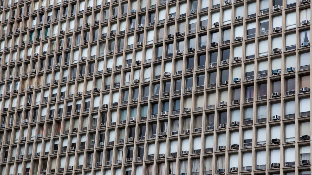 Window AC units in a large building from the outside.