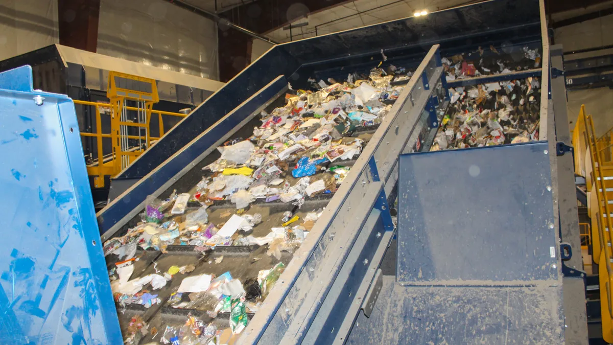 Equipment transports recyclable materials to be sorted.