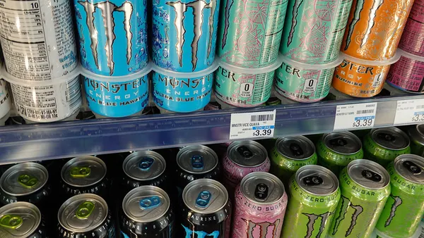 Cans of Monster Beverage on store shelves.