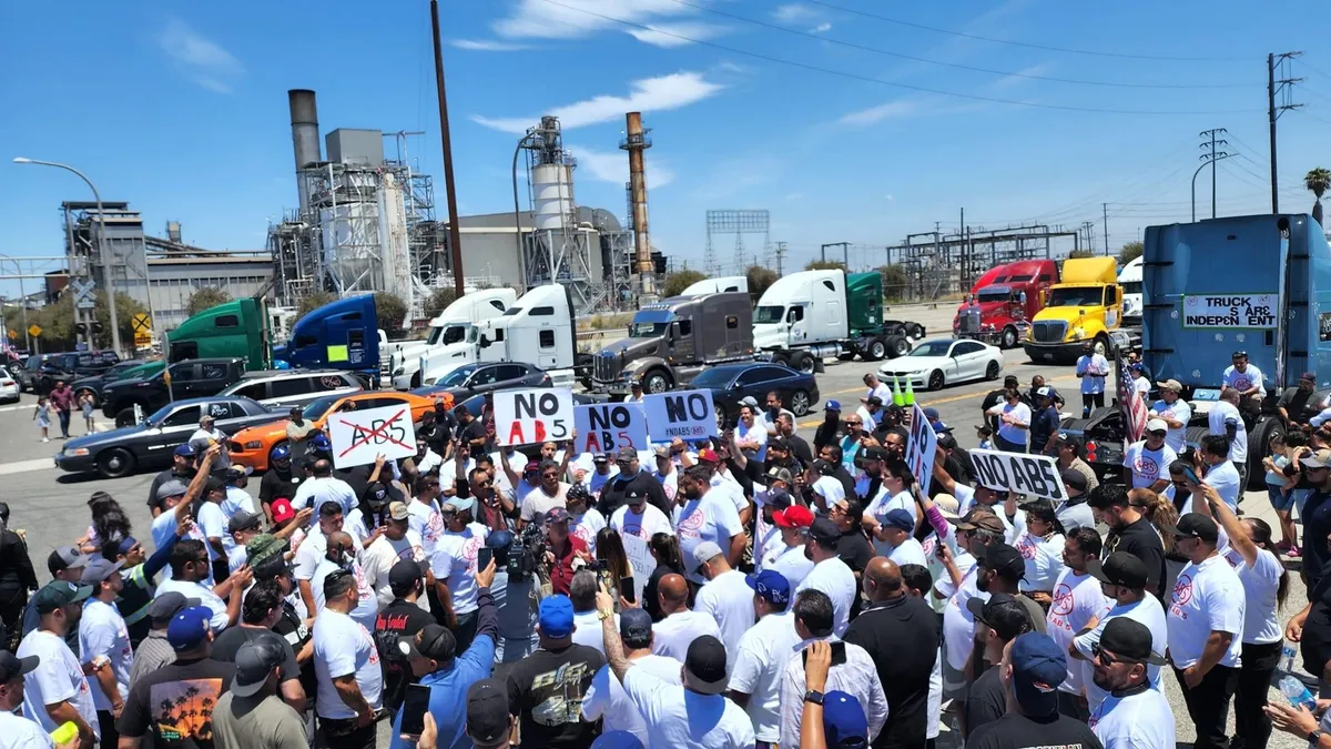 A large group of owner-operator truck drivers near the ports of Los Angeles and Long Beach stage a protest against California's AB5 labor law.