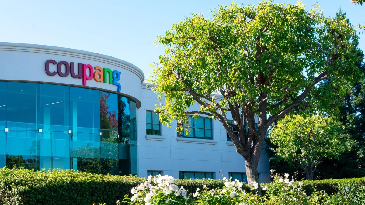 Coupang sign on company headquarters as seen from outside on a sunny day.