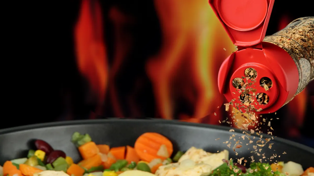 Pouring spices on food