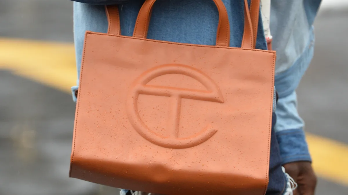 A model is pictured wearing a Telfar tote bag.