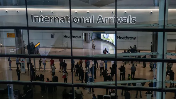 Travelers arrive at London's Heathrow Airport.