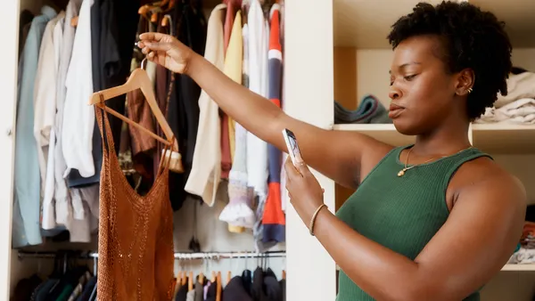 A person takes a photo of an item of clothing.