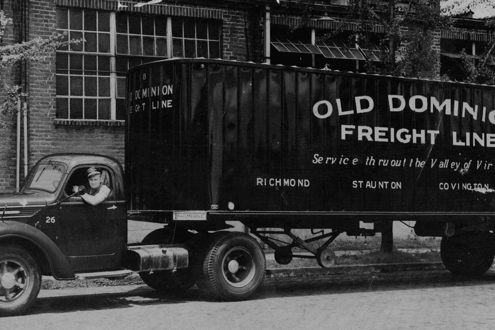 A person sits in a freight truck.