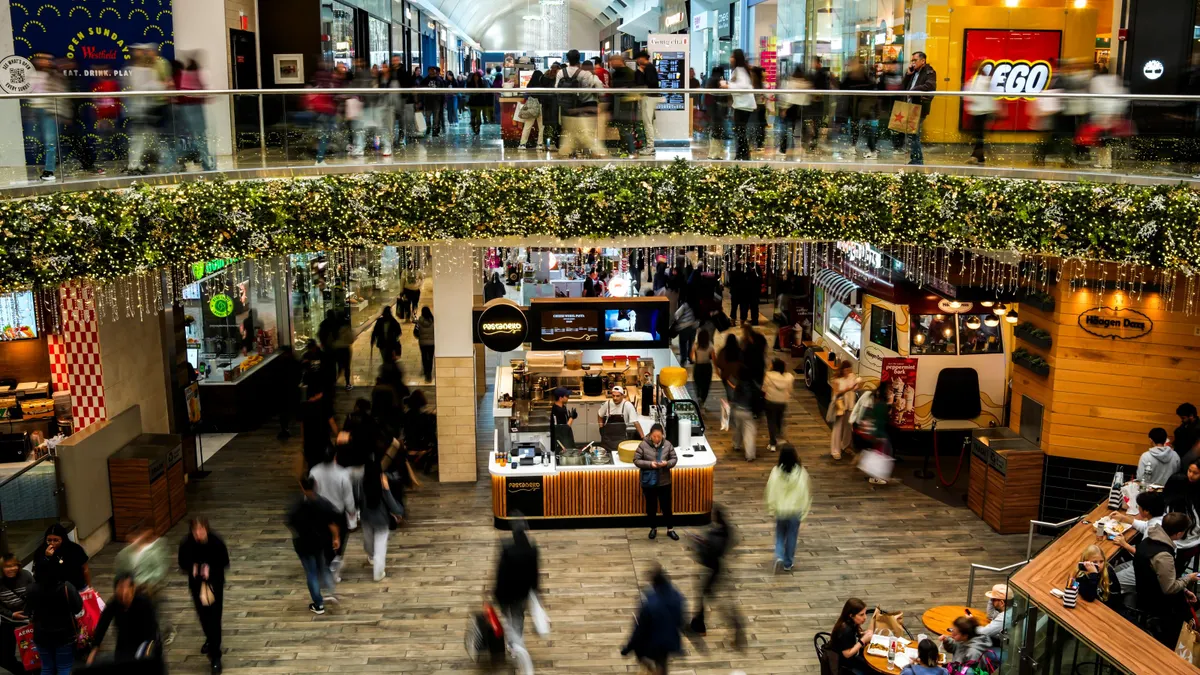 People walk in a shopping mall.