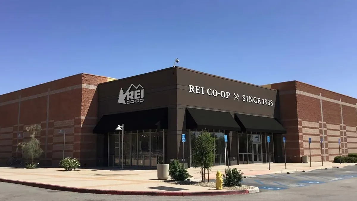 A one-story store sits on a corner against a blue sky.