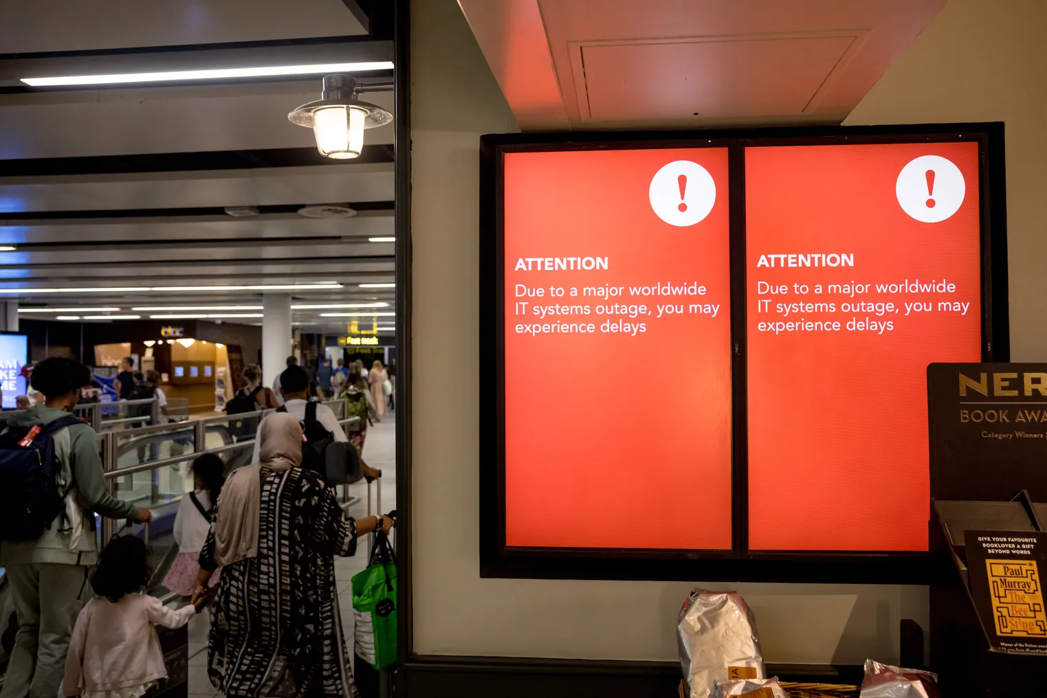 A screen showing a technical error message in an airport hallway