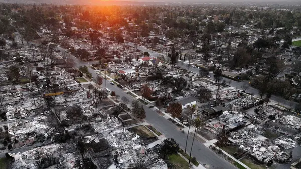 An aerial view of burned out houses on a city street.