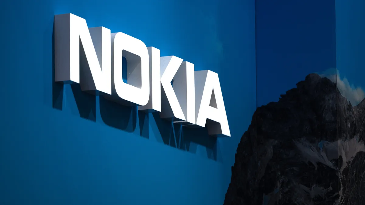 A Nokia logo sits illuminated on the wall.