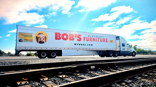 A freight truck with a Bob's Discount Furniture logo and mascot.
