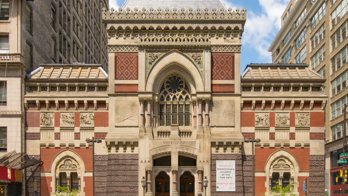 A historic brown and beige building that resembles a large church