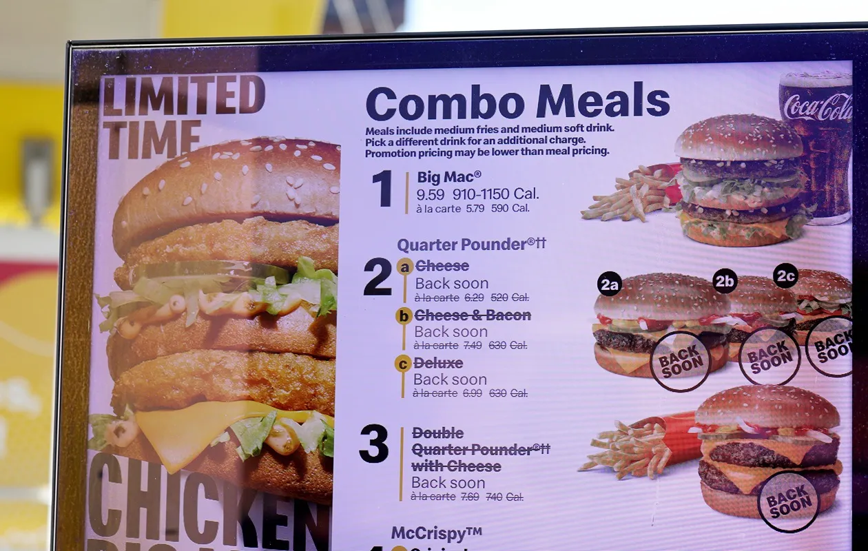 An image of a McDonald&#x27;s sign with Combo Meals. The Quarter Pounder meals are crossed out and say they will be back soon.