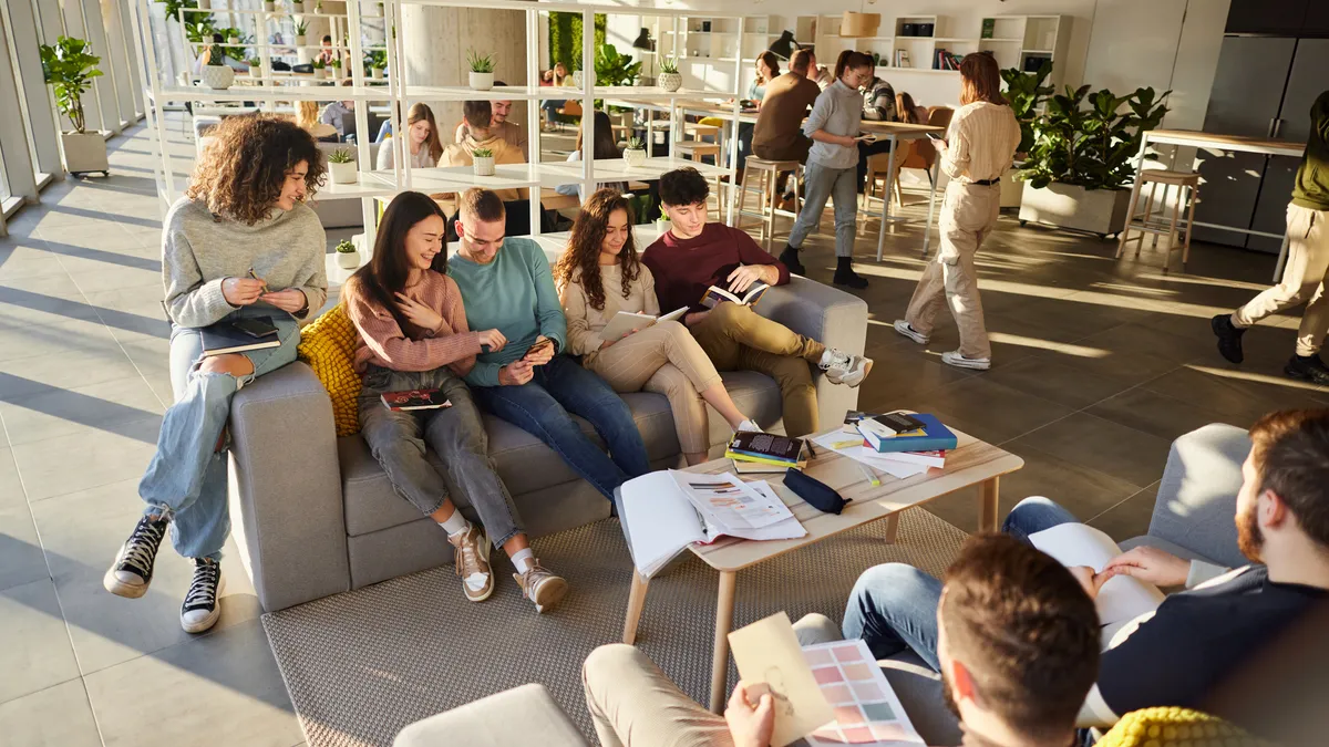 College students gather in a lounge space.