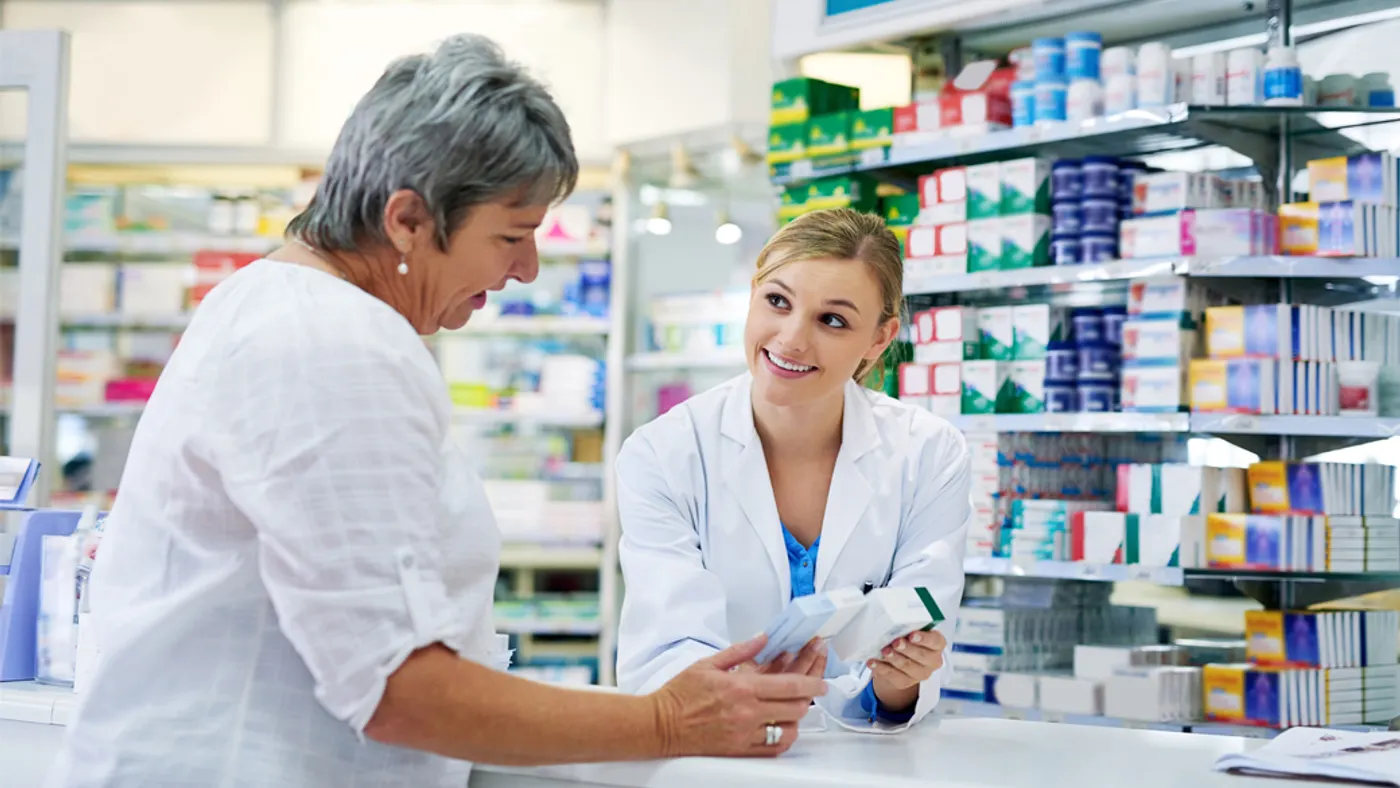 Pharmacist explaining medicine to a woman in the pharmacy