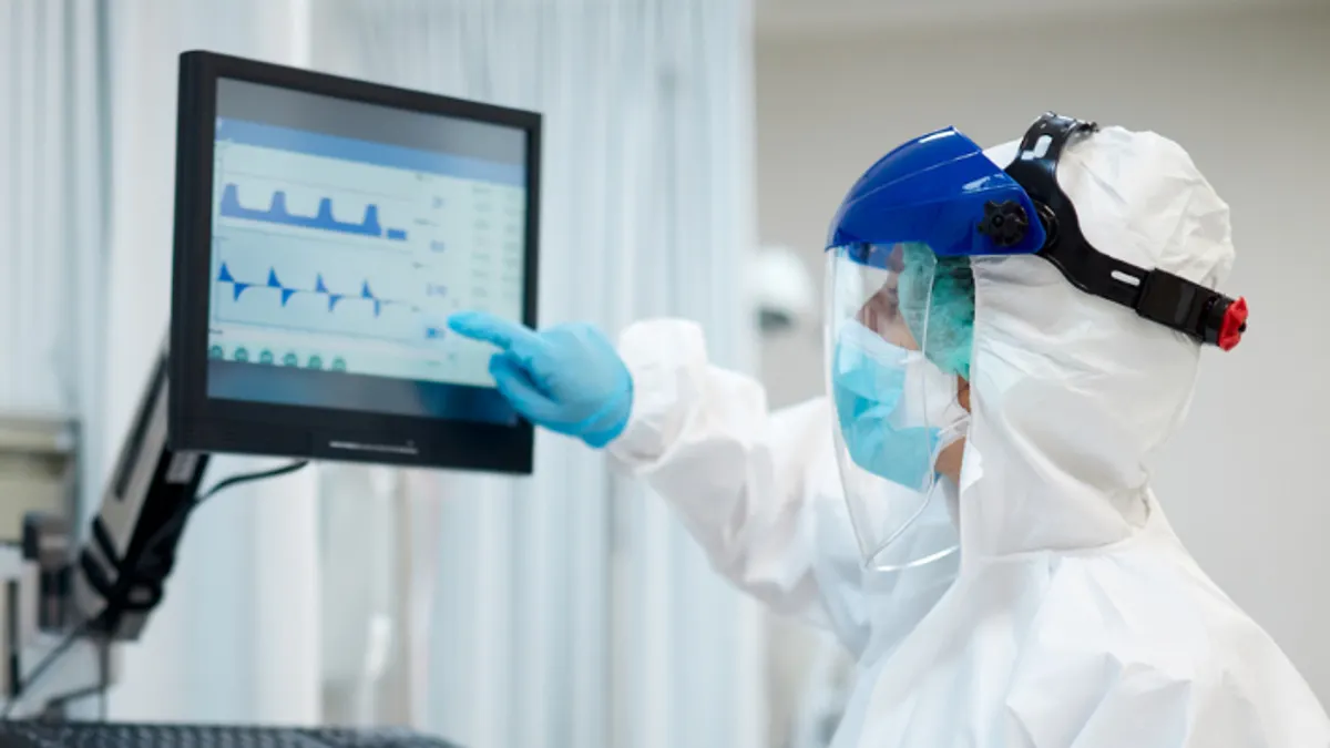 Doctors Looking at Medical Ventilator Screen in Hospital