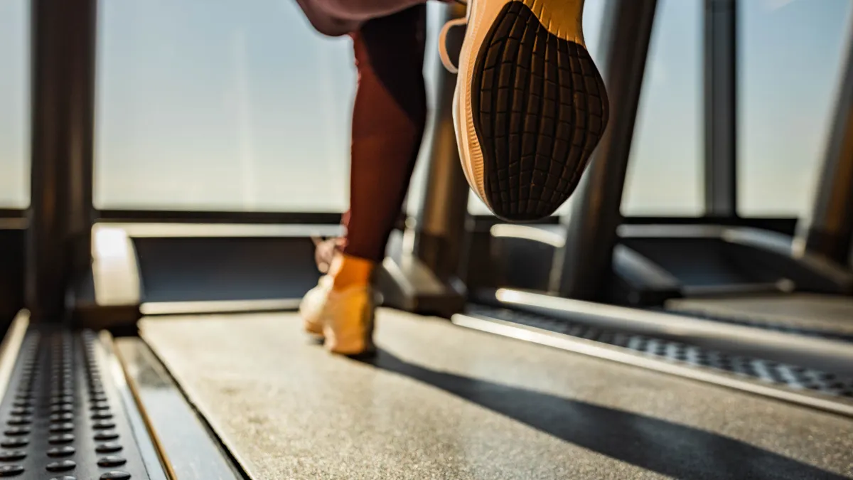 Close up of woman running on a treadmill