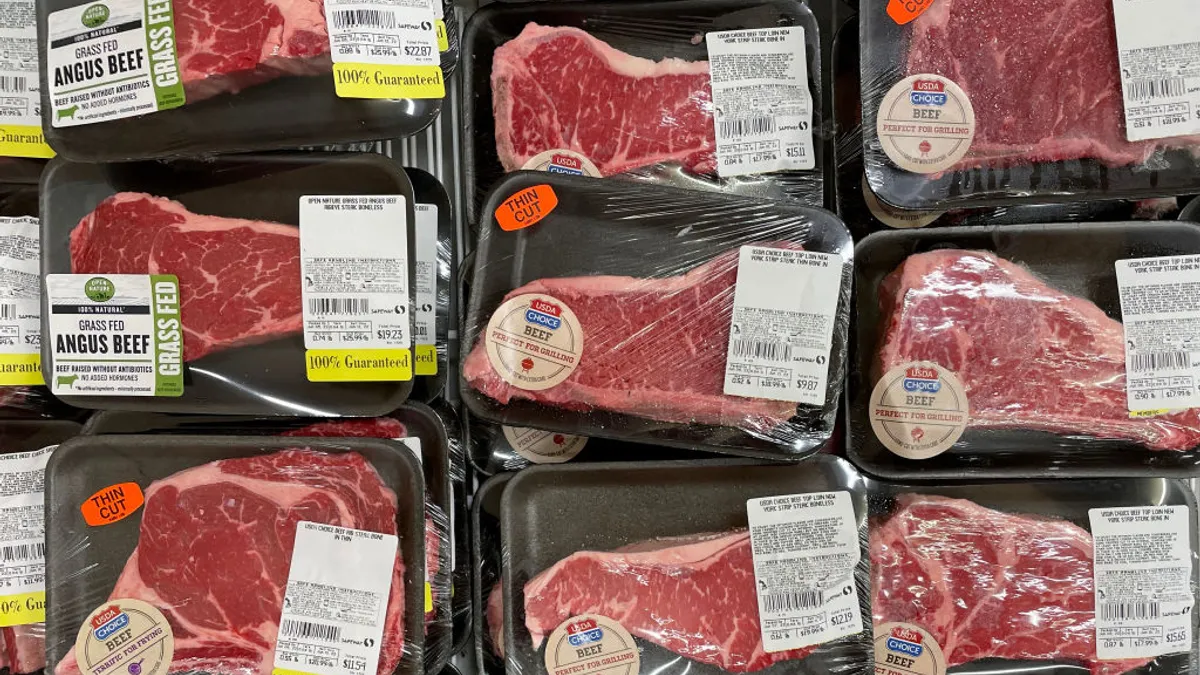 Beef steaks are displayed in the meat section