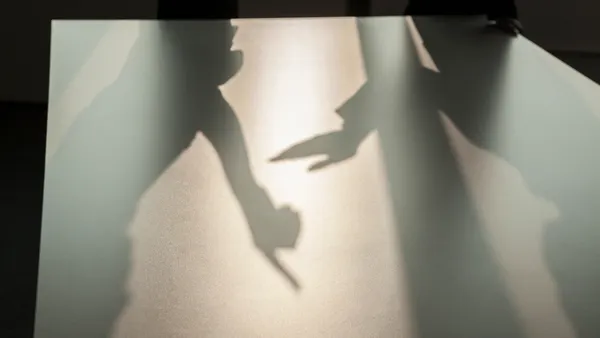 Shadow of two business people arguing and gesturing on the floor of the office