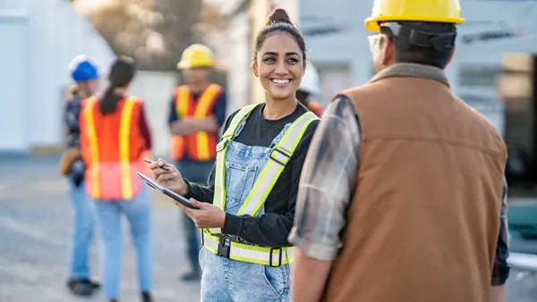 A group of construction workers smiling and talking.