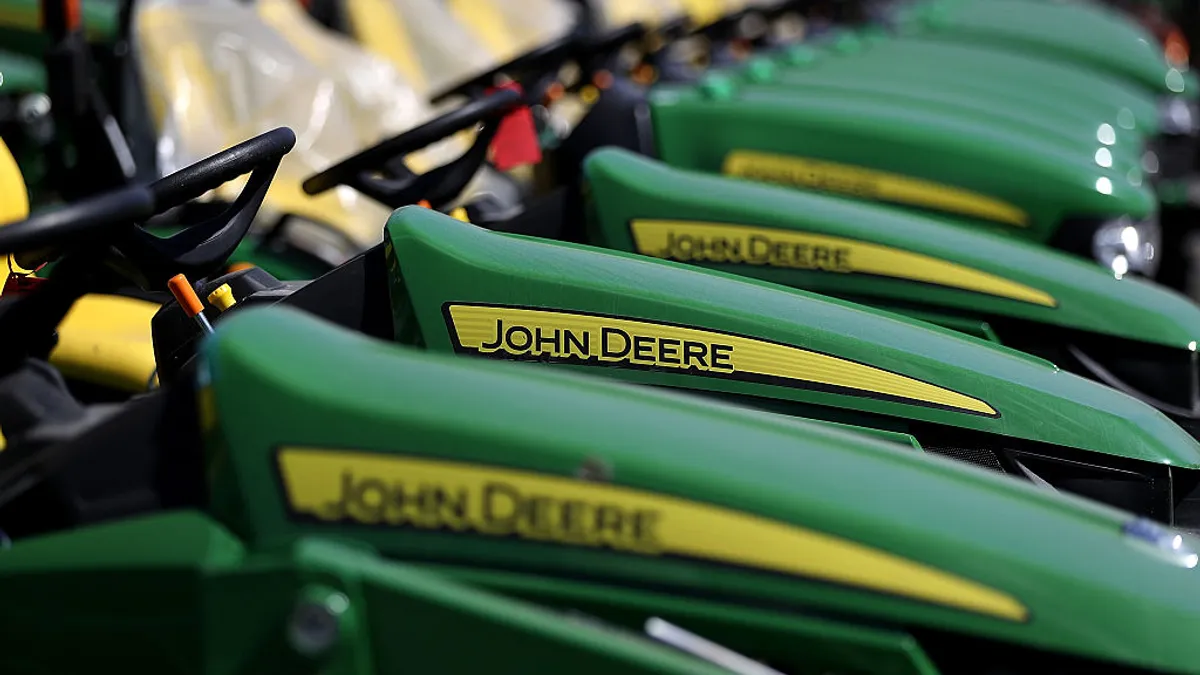 A line of green and yellow John Deere tractors