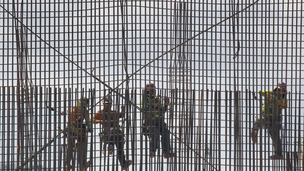 Construction workers are seen as they work with steel rebar during construction