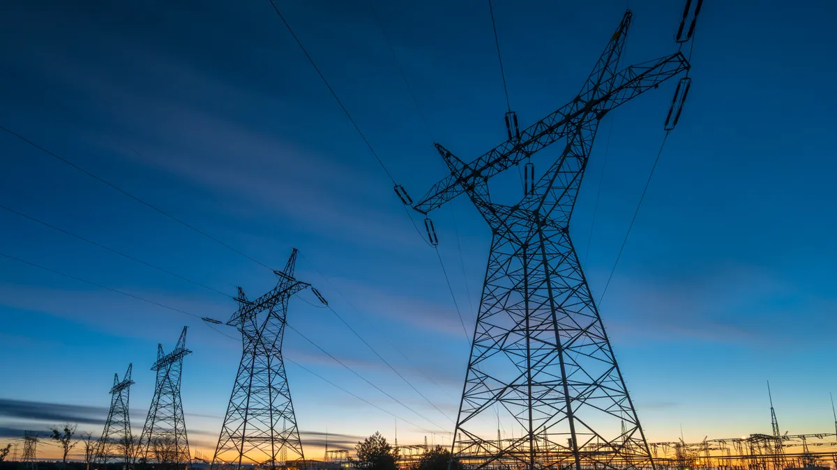 high-voltage power lines and high voltage electric transmission tower in a twilight