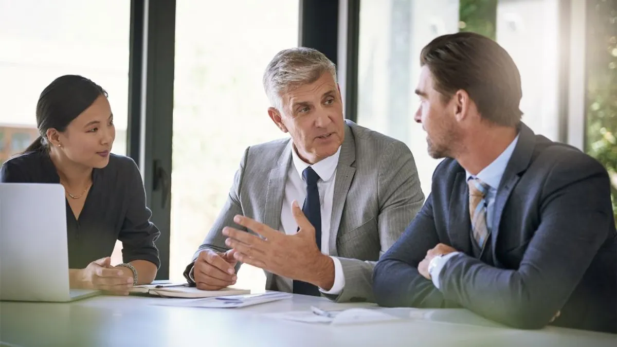 Meeting, collaboration and planning with a manager and team in the boardroom.