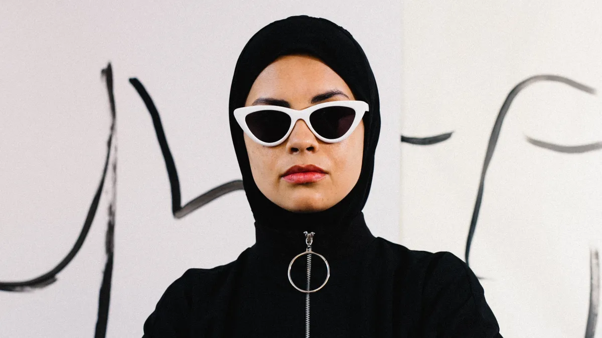 A person wearing a hijab and sunglasses