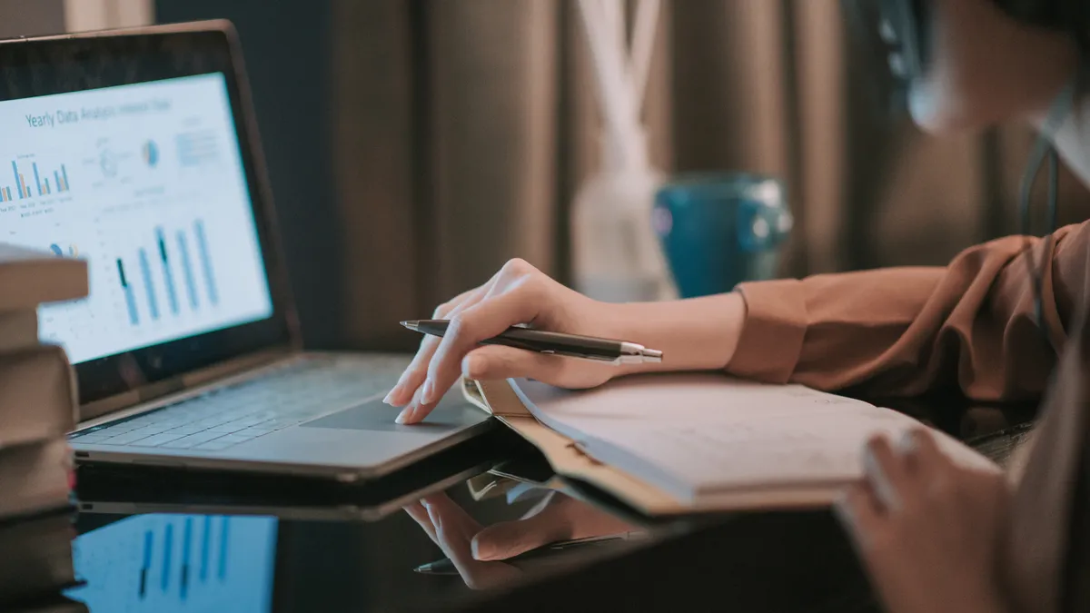 A woman looking at a computer.