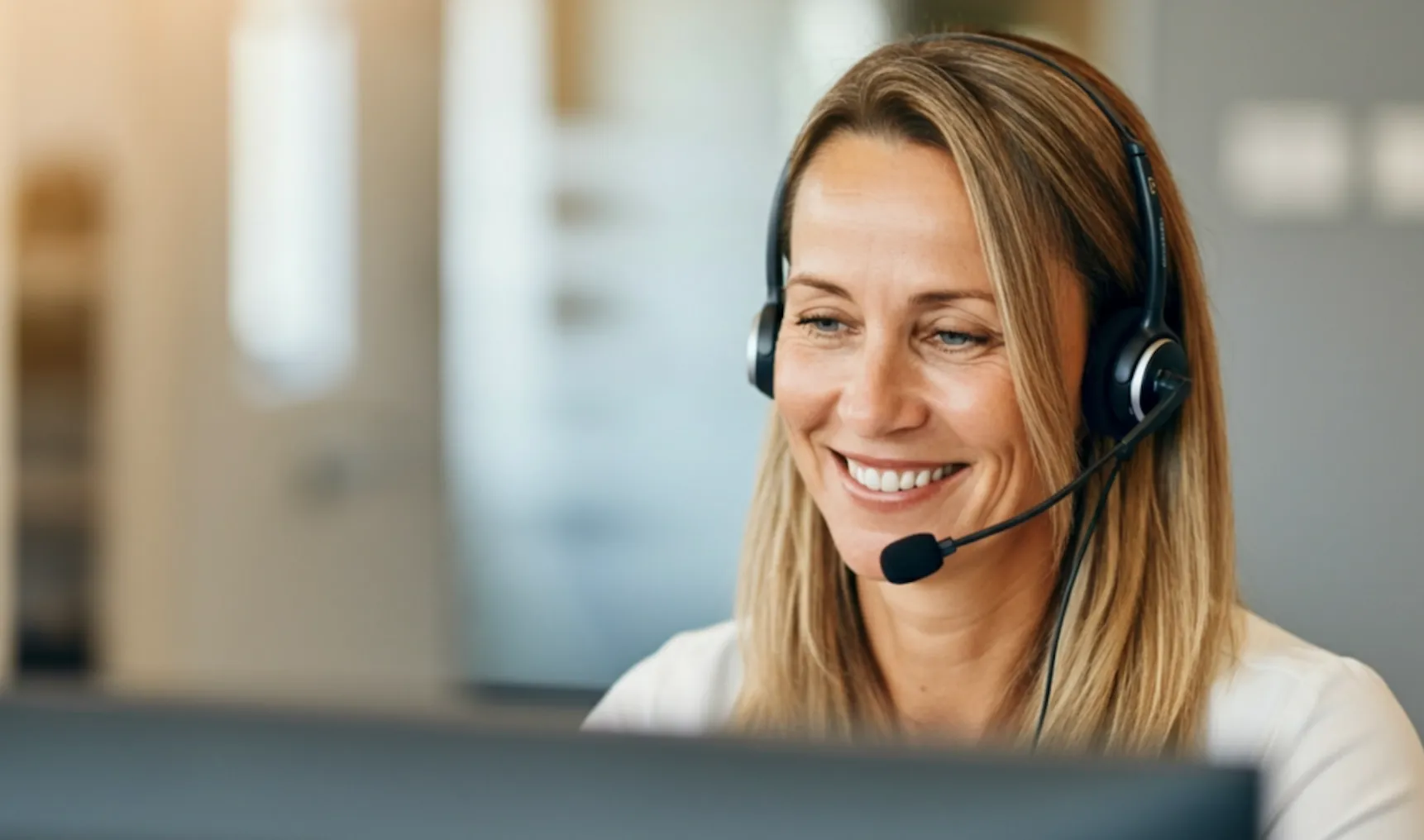 Woman smiling at computer