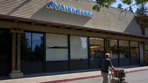 A customer walks by an Albertsons store.