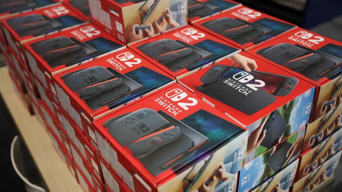Packaged Nintendo Switch 2 consoles in boxes are displayed on a table.